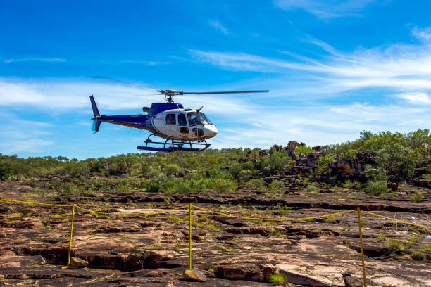 Helicopter lands on Mitchell Falls in outback Western Australia.