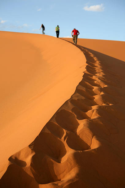 Three people trekking to the summit stock photo