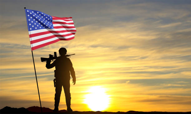 istock Silhouette of a soldier with American flag 1460680486