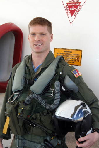 United States Navy jet fighter pilot in front of his jet