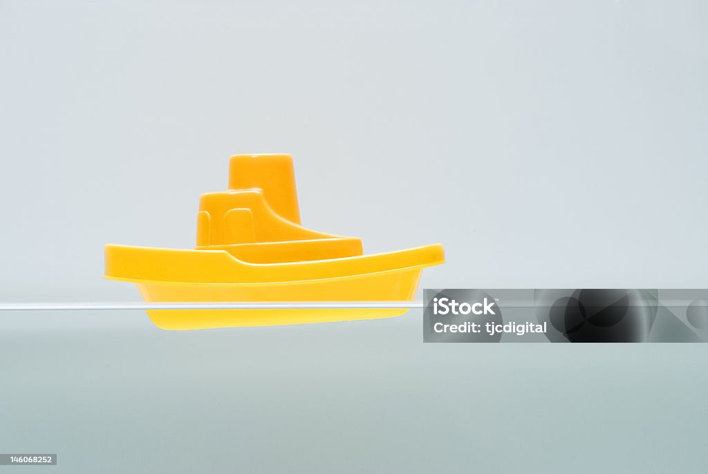 Bathroom Boat Toy boat in the bath at waterline level. Toy Boat Stock Photo