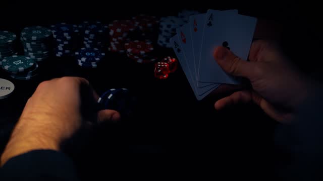 The player watches art while playing poker. A combination of four aces, four of a kind, winning cards fell out.