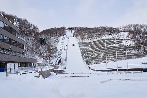 Hokkaido, Japan  - December 21, 2022 : The Okurayama Ski Jump Stadium in Sapporo City is a ski jumping venue and view point located in the Miyanomori area, Sapporo, Hokkaido, Japan.