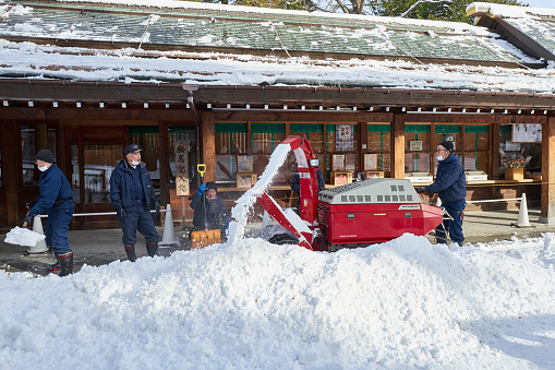 Hokkaido, Japan  - December 21, 2022 : Workers do snow removal work at the Hokkaido Shrine in Sapporo, Hokkaido