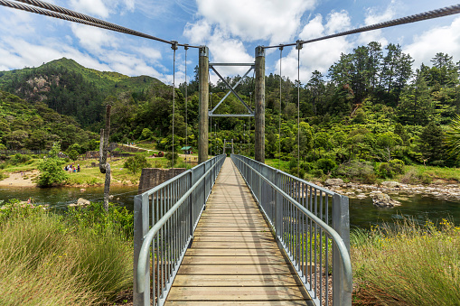 Hauraki District, New Zealand -  January 01, 2023: View of a suspension footbridge at Karangahake Gorge track