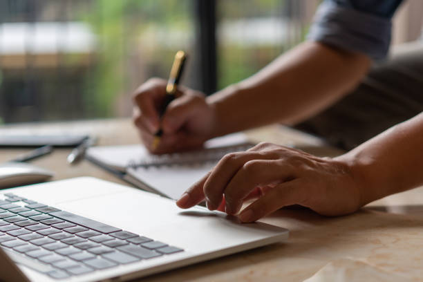istock Hands typing on a keyboard.Businessman working on new project with notebook computer, job search, search internet information online, shopping online. 1460687459