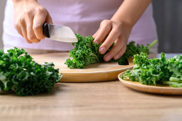 istock Green Kale or leaf cabbage cutting on wooden board, Healthy vegetable 1460687544