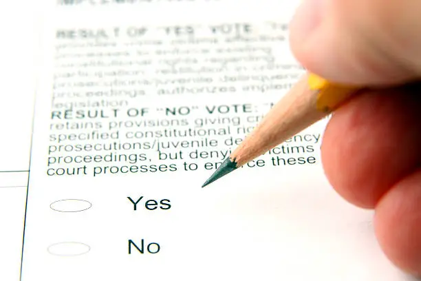 Person filling out ballot, shallow depth of field