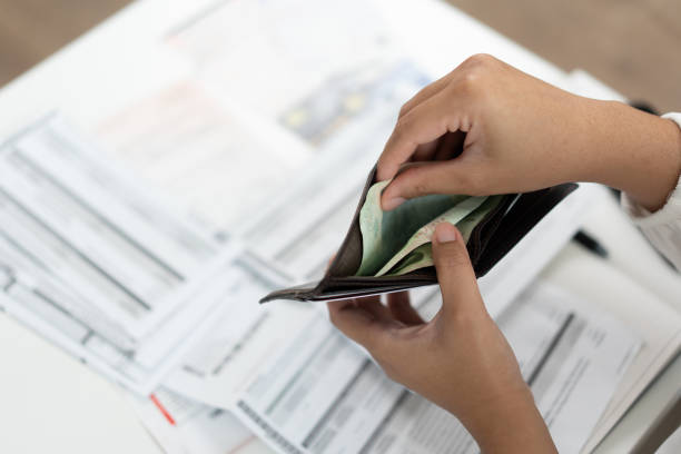 istock Worried unemployment woman open empty wallet on payday 1460692336