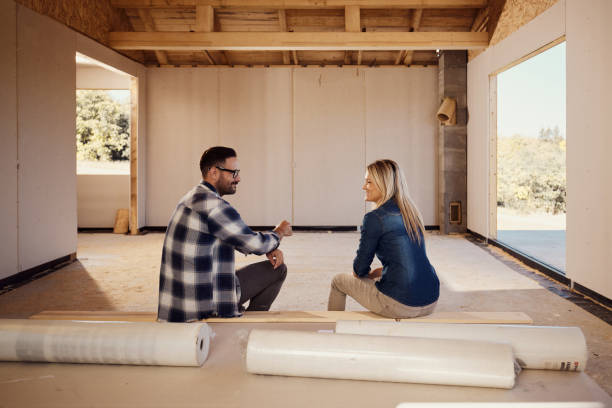 istock Happy couple talking inside of their developing house. 1460692806
