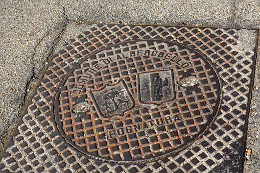 Metal manhole cover on the street of Alberobello