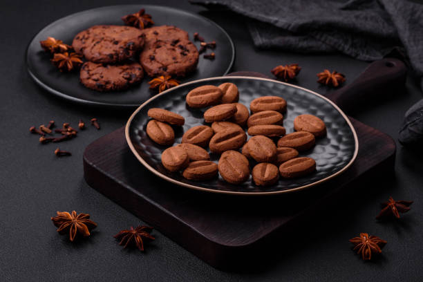 istock Delicious chocolate cookies with nuts on a black ceramic plate 1460695365