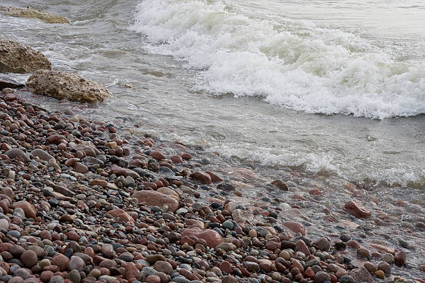 Shingle beach and sea waves stock photo