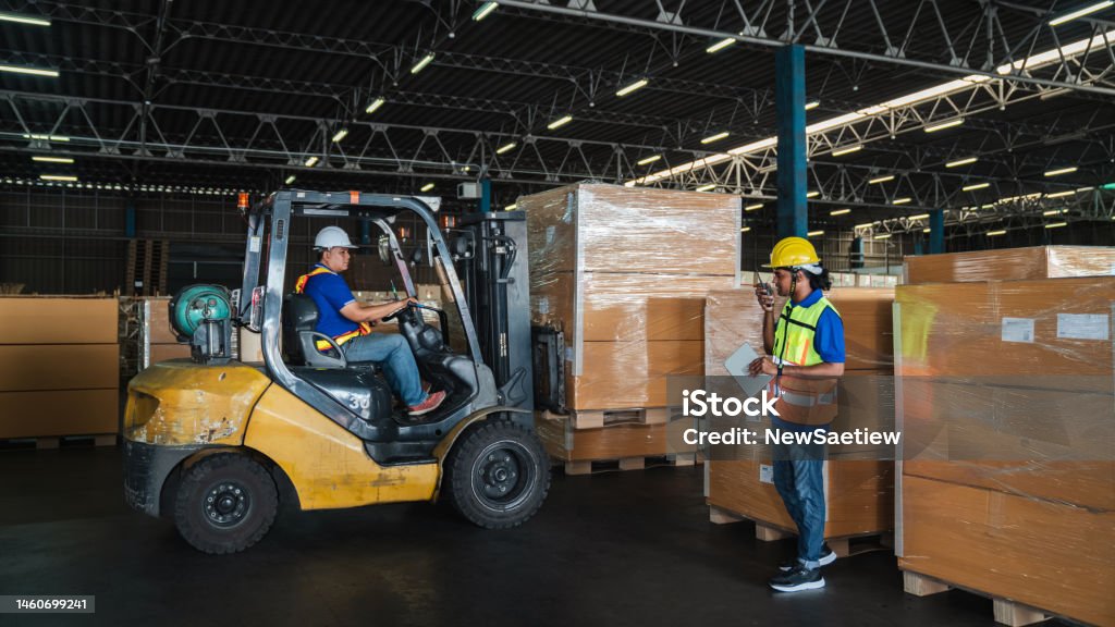 Warehouse Worker Workers With Forklift In A Warehouse Use Forklift