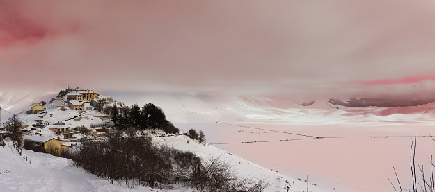 Panoramic view of Castelluccio di Norcia at sunset (Umbria). Snowy landscape in Umbria.