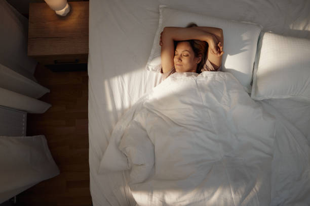 istock Above view of smiling woman sleeping in bed. 1460700935