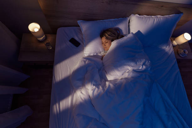 istock Above view of relaxed woman sleeping in bed. 1460700986
