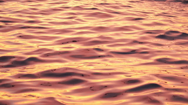 Brilliant dramatic golden sunrise reflecting on the surface of the ocean