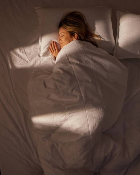 Above view of a woman sleeping in bed.