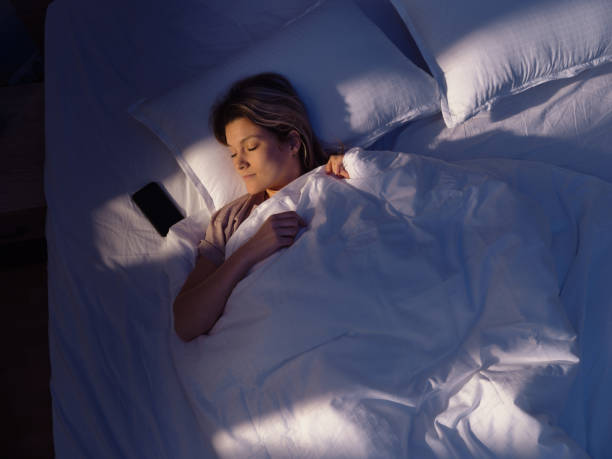 istock Above view of young woman sleeping in bed. 1460701689