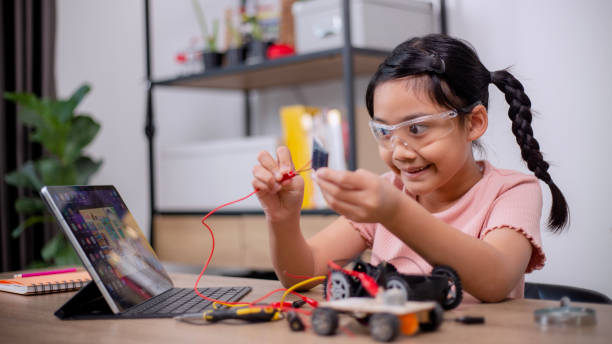 istock Asian students learn at home by coding robot cars and electronic board cables in STEM, STEAM, mathematics engineering science technology computer code in robotics for kids' concepts. 1460701693