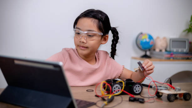 istock Asian students learn at home by coding robot cars and electronic board cables in STEM, STEAM, mathematics engineering science technology computer code in robotics for kids' concepts. 1460701740