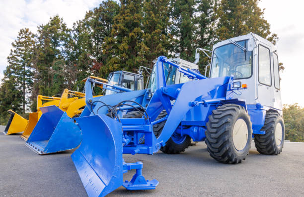 New, shiny and modern yellow excavator machines waiting on buyers. 