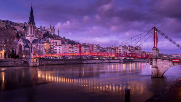 Lyon, France - january 13, 2023 : Cityscape of the banks of the Saône in Lyon and the Saint Georges footbridge at dusk