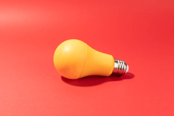 istock Yellow Light Bulb on red background 1460708130