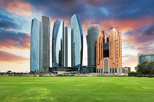 Skyscrapers in Abu Dhabi at dramatic sunset; United Arab Emirates