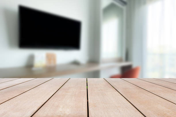 Empty old wood table in front of blurred beautiful living room looks clean and decorated in comfortable tones, suitable for relaxation. Can be used for display or montage for show your products. stock photo