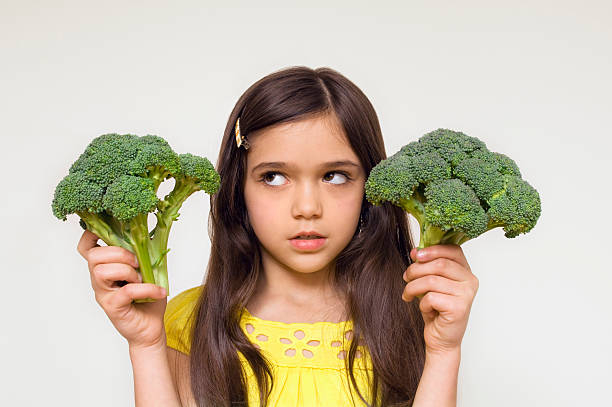 istock Girl holding broccoli 146071359