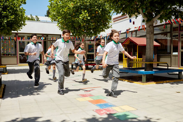 istock Competitive young children racing in sunny schoolyard 1460715256