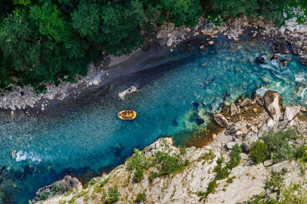 Aerial view of the blue river. Rafting in canyon of river Tara. Djurdjev, Montenegro – July 29, 2021: The aerial view of the blue river. Rafting in canyon of river Tara. rafting stock pictures, royalty-free photos & images
