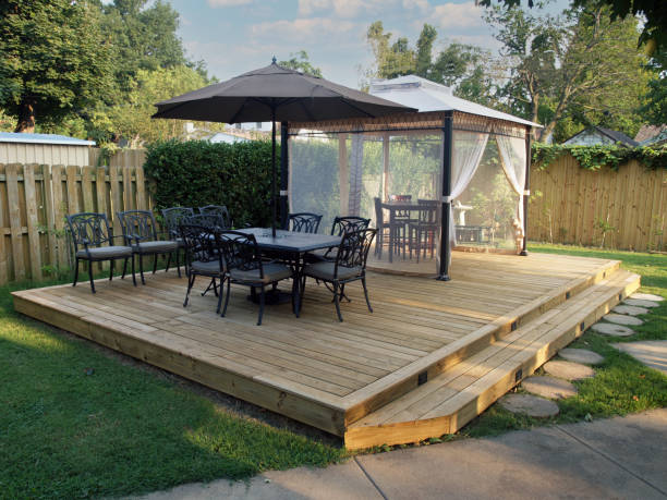 Backyard Deck with Dining and Cabana Outdoor living spaces like this cabana and deck are in demand during this era of stay at home vacations or staycations. decking stock pictures, royalty-free photos & images