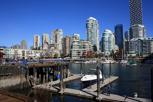 Vancouver, Canada – September 05, 2021: The port in Vancouver city in Canada with the seaside city in the background against a blue