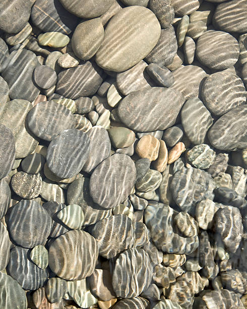 istock Many pebbles and stones in shallow water 146071650