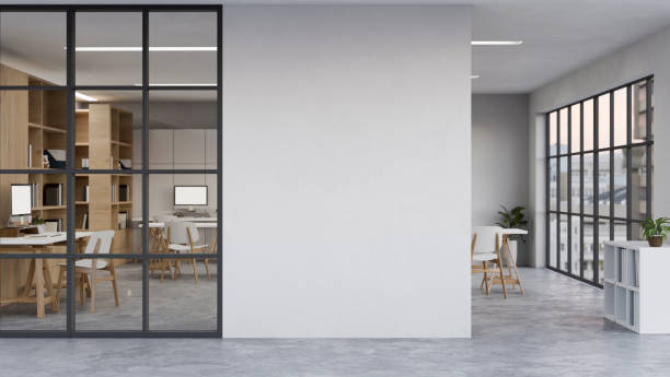 istock Modern urban office indoor building interior with co-working space, computer desk and office decor 1460716545