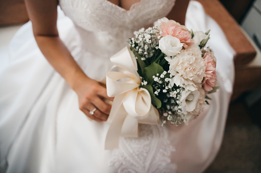 the bride holds a colorful wedding bouquet in her hands