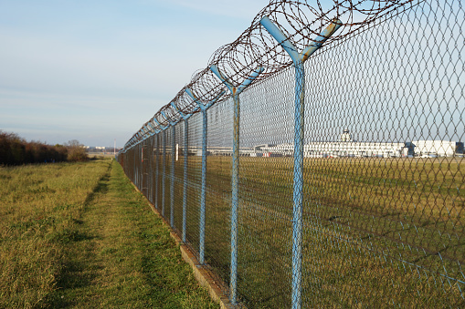 Airport security perimeter fencing system with razor wire, Prague, Czech Republic