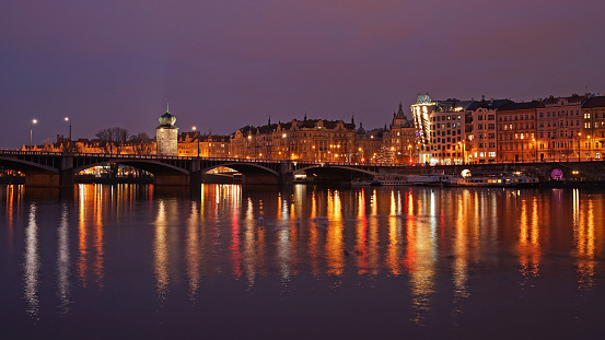 Historic Prague city center in night, lights mirroring in river, dancing house and Manes landmarks, Prague, Czech Republic