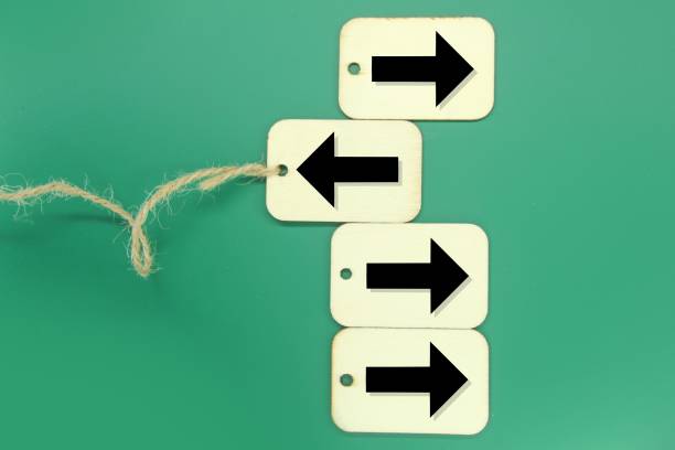 istock wooden tags with arrows one in a different direction and another in a different direction 1460720628