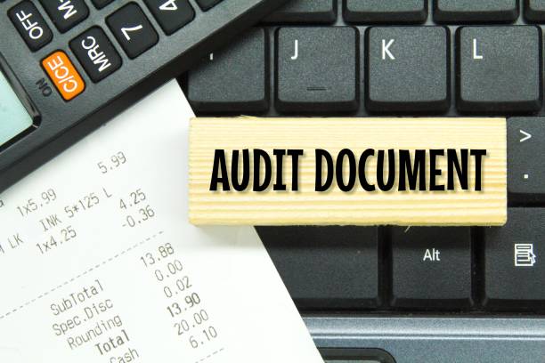 istock receipts, calculators, computer keyboards and wooden boards with the word audit document 1460720740
