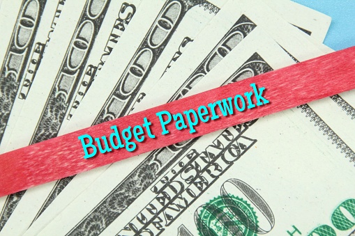 paper money, a stick of red ice cream with the word budget paperwork concept
