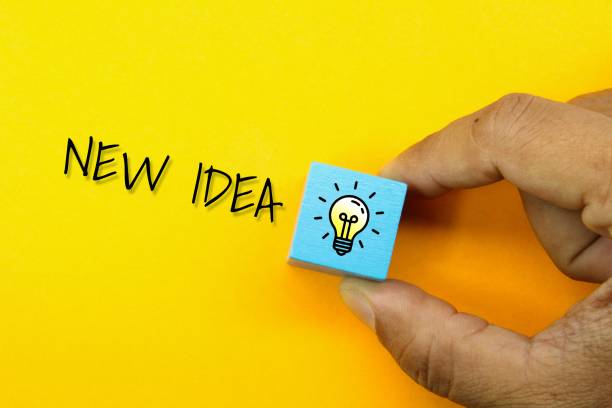 istock a hand holding a lighted bulb with the word new idea. concept idea 1460720939