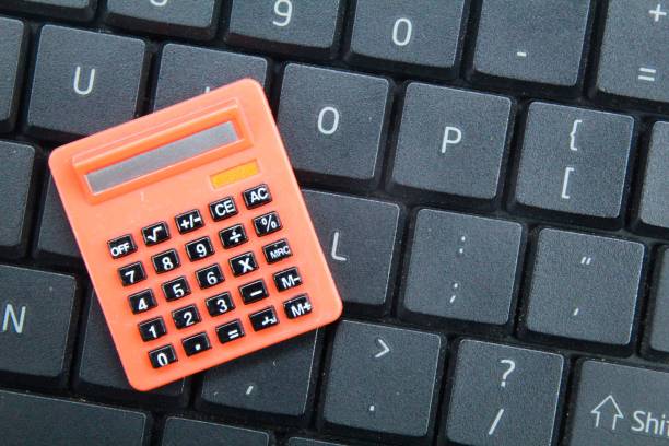 istock laptop keyboard with calculator. the concept of computation or audit 1460721358