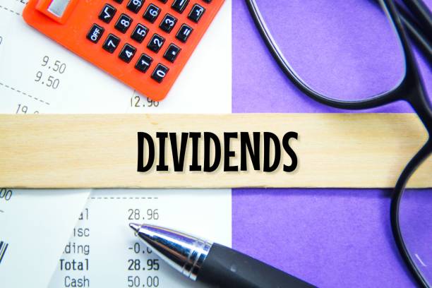 istock calculators, receipts, glasses with the word dividends 1460721402
