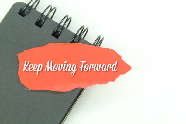 istock black notebooks and torn paper with the words keep moving forward 1460721510