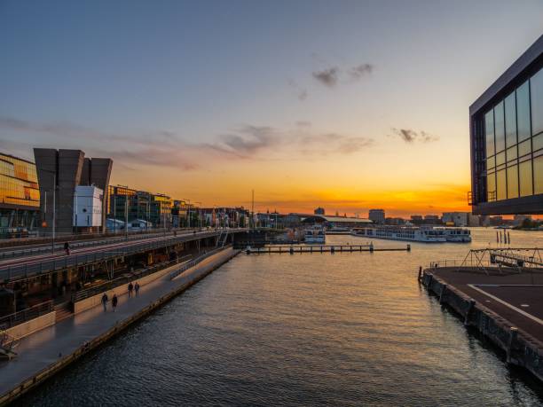 istock View of a river and modern buildings during scenic sunset, Amsterdam 1460722206