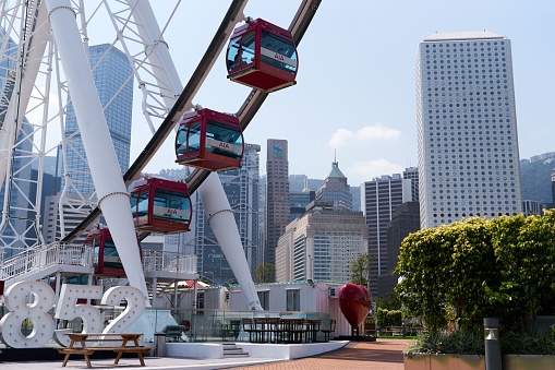 Hong Kong, Hong Kong – October 10, 2020: A giant Ferris Wheel next to modern buildings during daytime in Hong Kong